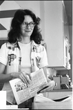 Woman with an <i>Aztec</i> newspaper, 1976