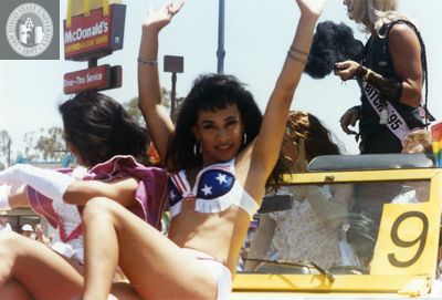Person posing on car in San Diego Pride parade, 1995