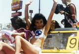 Person posing on car in San Diego Pride parade, 1995